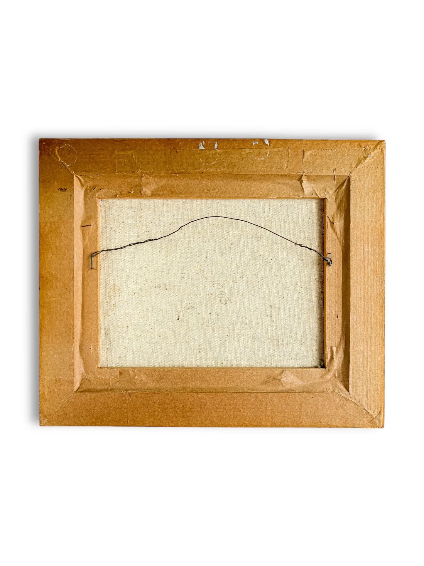 Back view of a rectangular framed canvas with brown cardboard backing and hanging wire