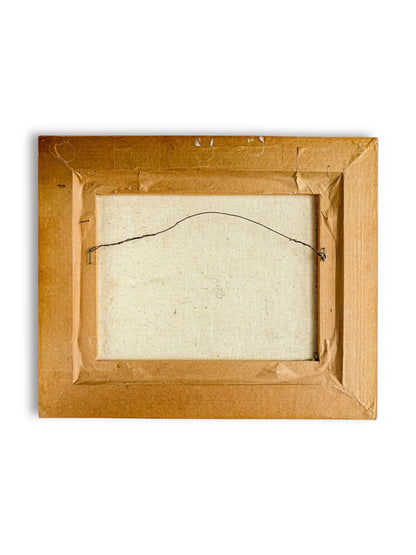 Back view of a rectangular framed canvas with brown cardboard backing and hanging wire