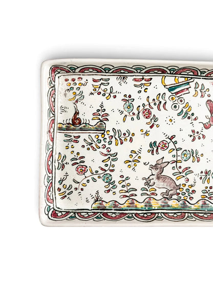 Close-up of grey hare and scalloped polychrome border on vintage Conimbriga Portuguese faience tray
