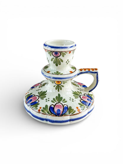 Hand-painted ceramic candlestick holder with floral design in blue, pink, green, and orange accents