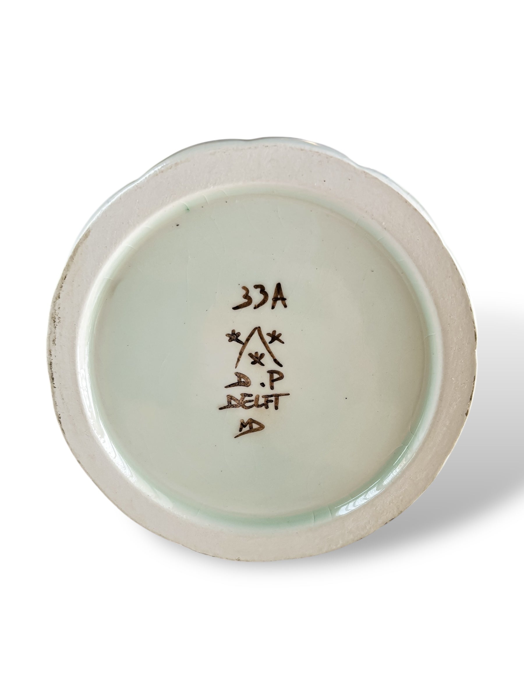 Bottom of vintage Delft porcelain plate with handwritten markings and signature