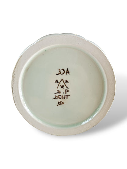 Bottom of vintage Delft porcelain plate with handwritten markings and signature