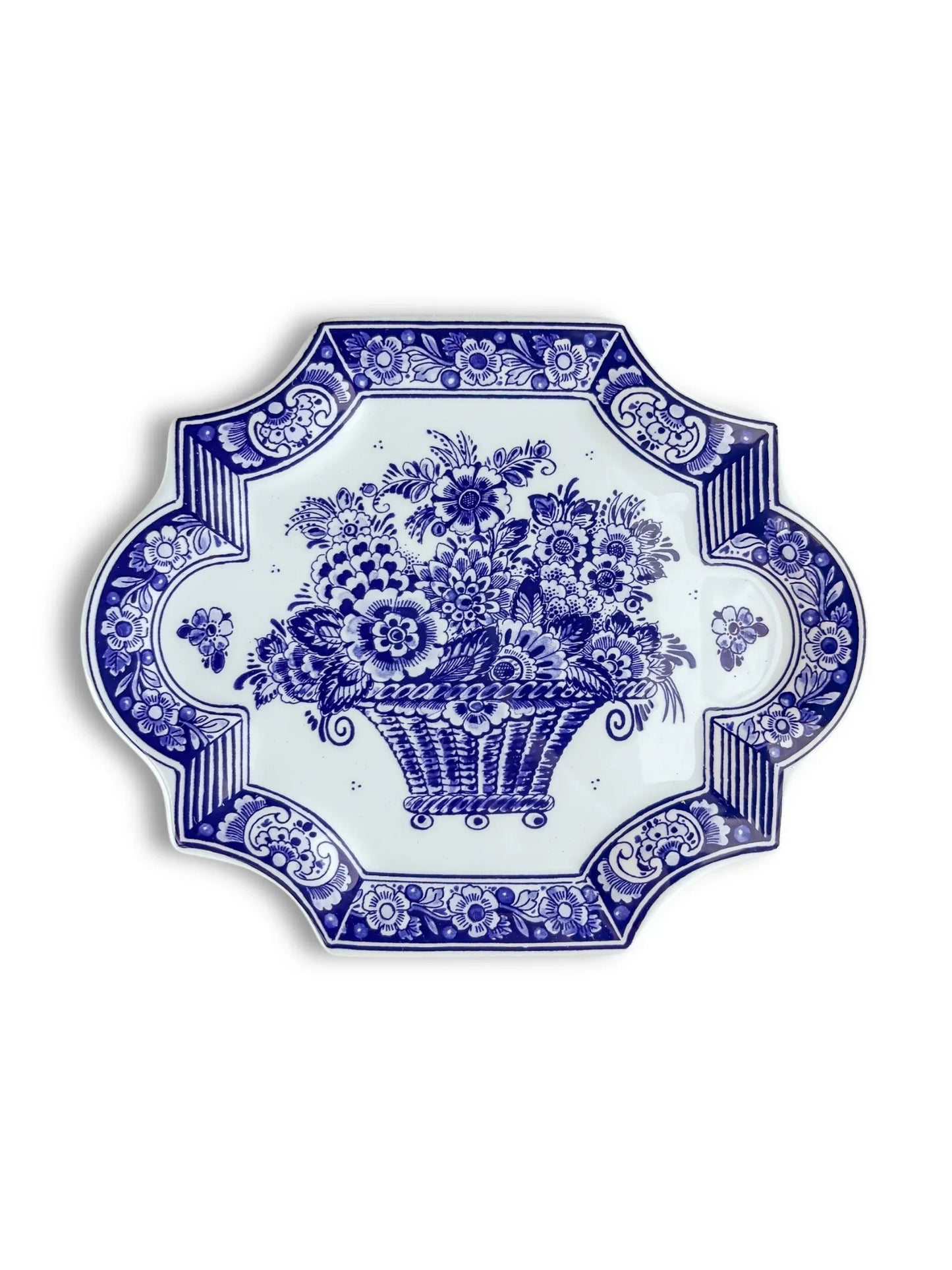 Blue and white ceramic plate with floral and basket pattern, ornate decorative border