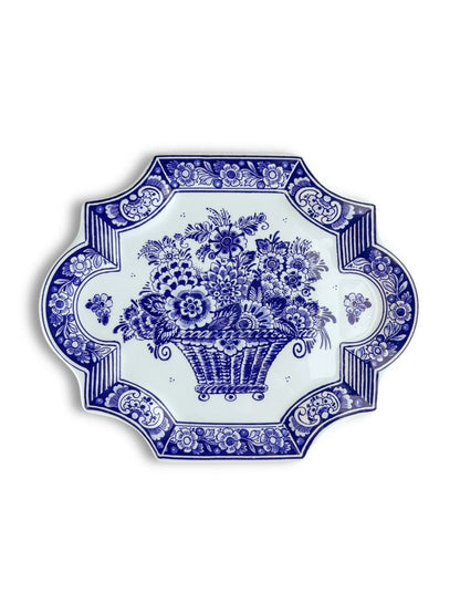 Blue and white ceramic plate with floral and basket pattern, ornate decorative border