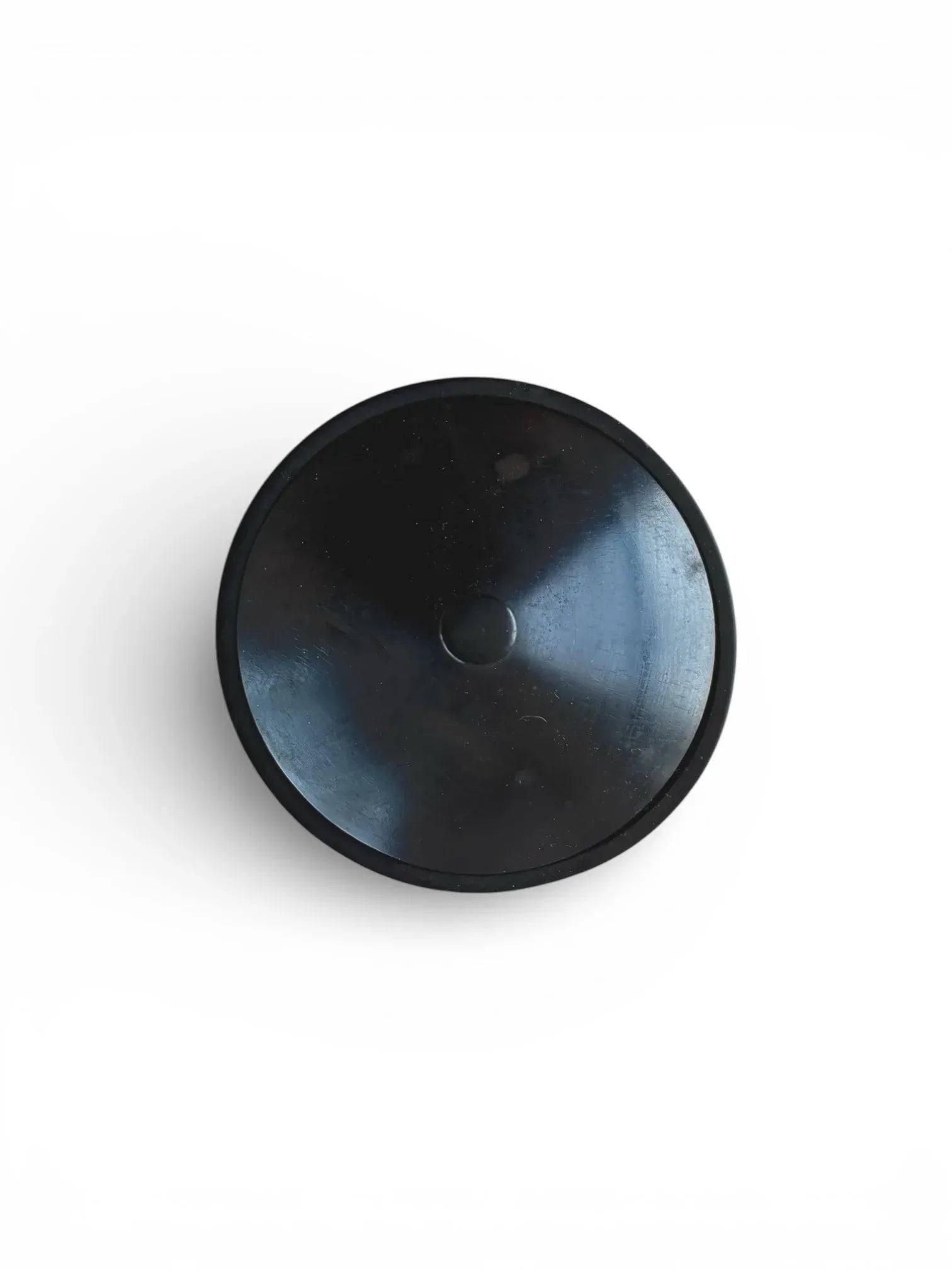 Top-down view of the lid of a black turned wood box, showcasing the central cylindrical knob and smooth ebonised finish.