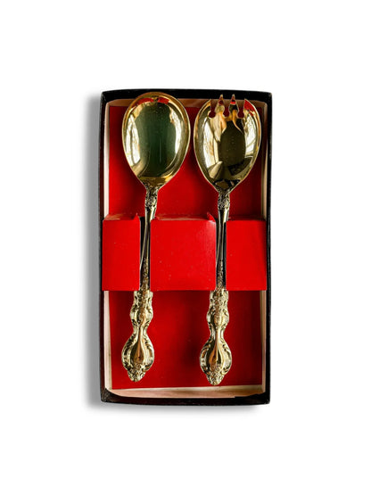 Set of ornate gold salad serving spoon and fork in a red and black gift box