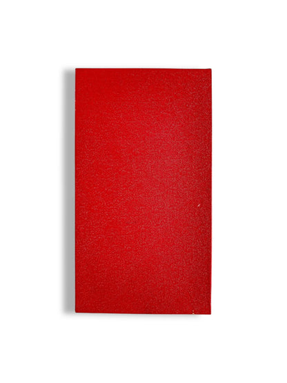 Closed red hardcover book with textured surface on white background
