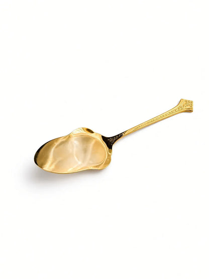 Eetrite Fleur gold plated serving spoon on a white background, angled to show the bowl and floral handle
