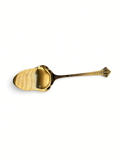 Overhead view of the Eetrite Fleur serving spoon on a white background, showing the front of the bowl and handle