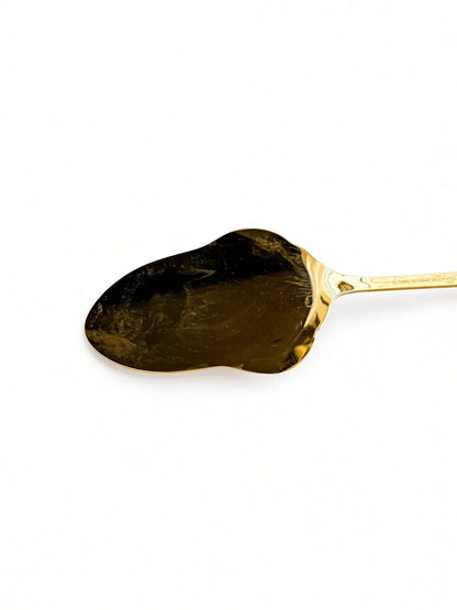 Close-up of the reverse of the spoon bowl showing wear and thinning to the gold plate