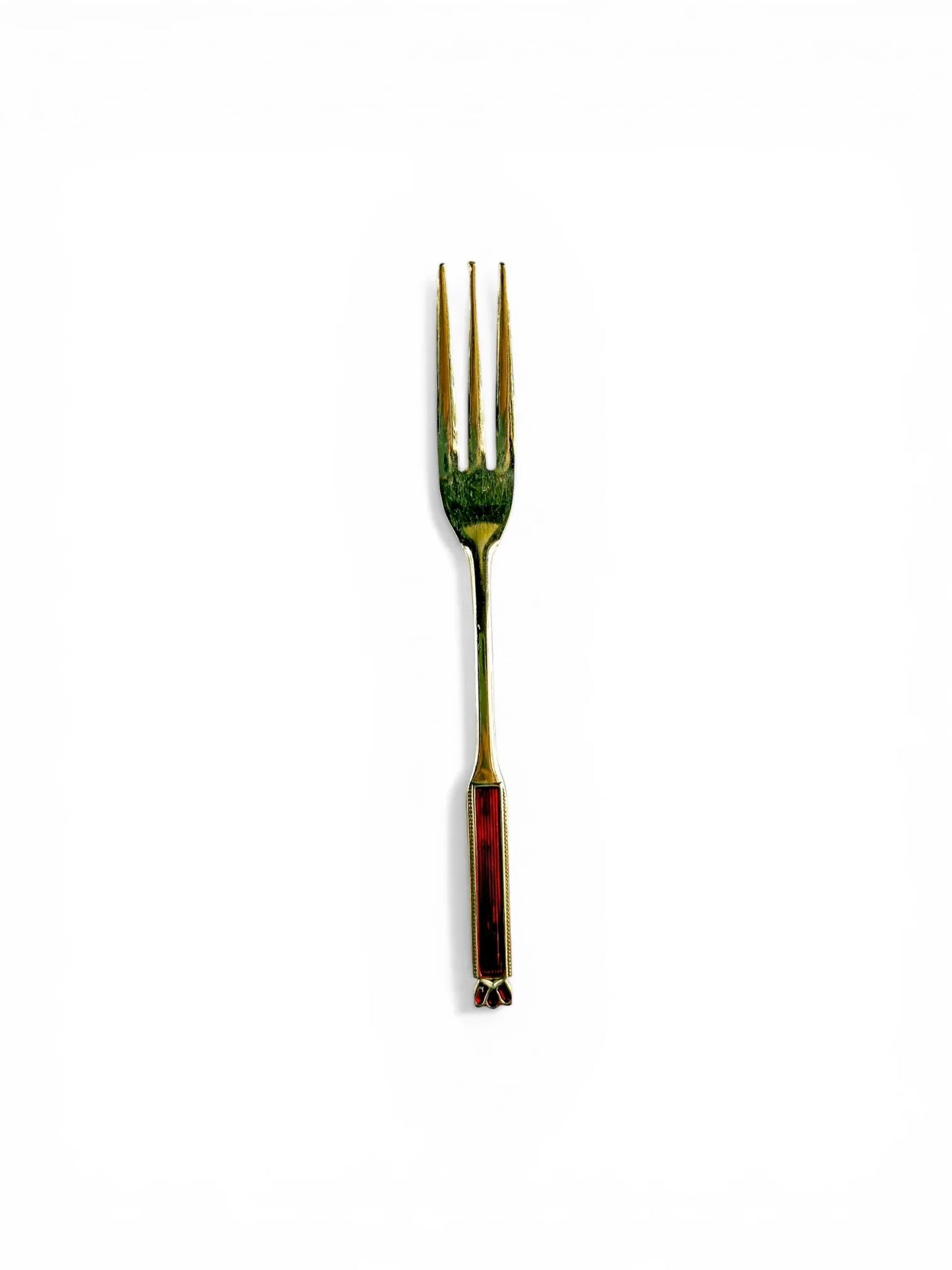 A single Eetrite gold-plated cake fork shown vertically, highlighting the three-tine design and the detailed red enamel handle.