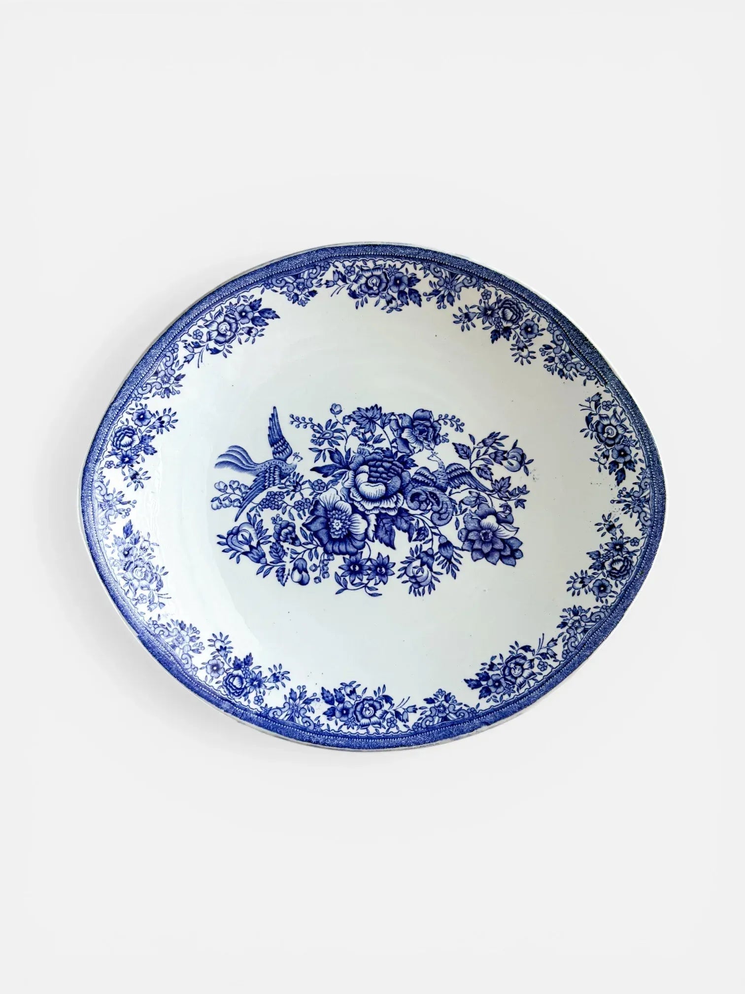 Top-down view of a vintage Egersund Fayancefabrik Blue Fasan oval serving dish featuring a central pheasant and floral transferware design in cobalt blue on white ironstone.