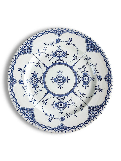 White ceramic plate with intricate blue floral and geometric patterns in vintage style