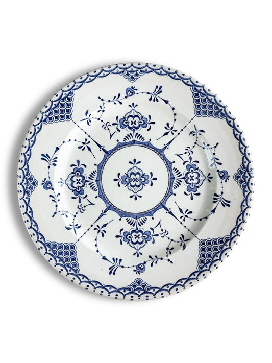 White ceramic plate with intricate blue floral and geometric patterns in vintage style