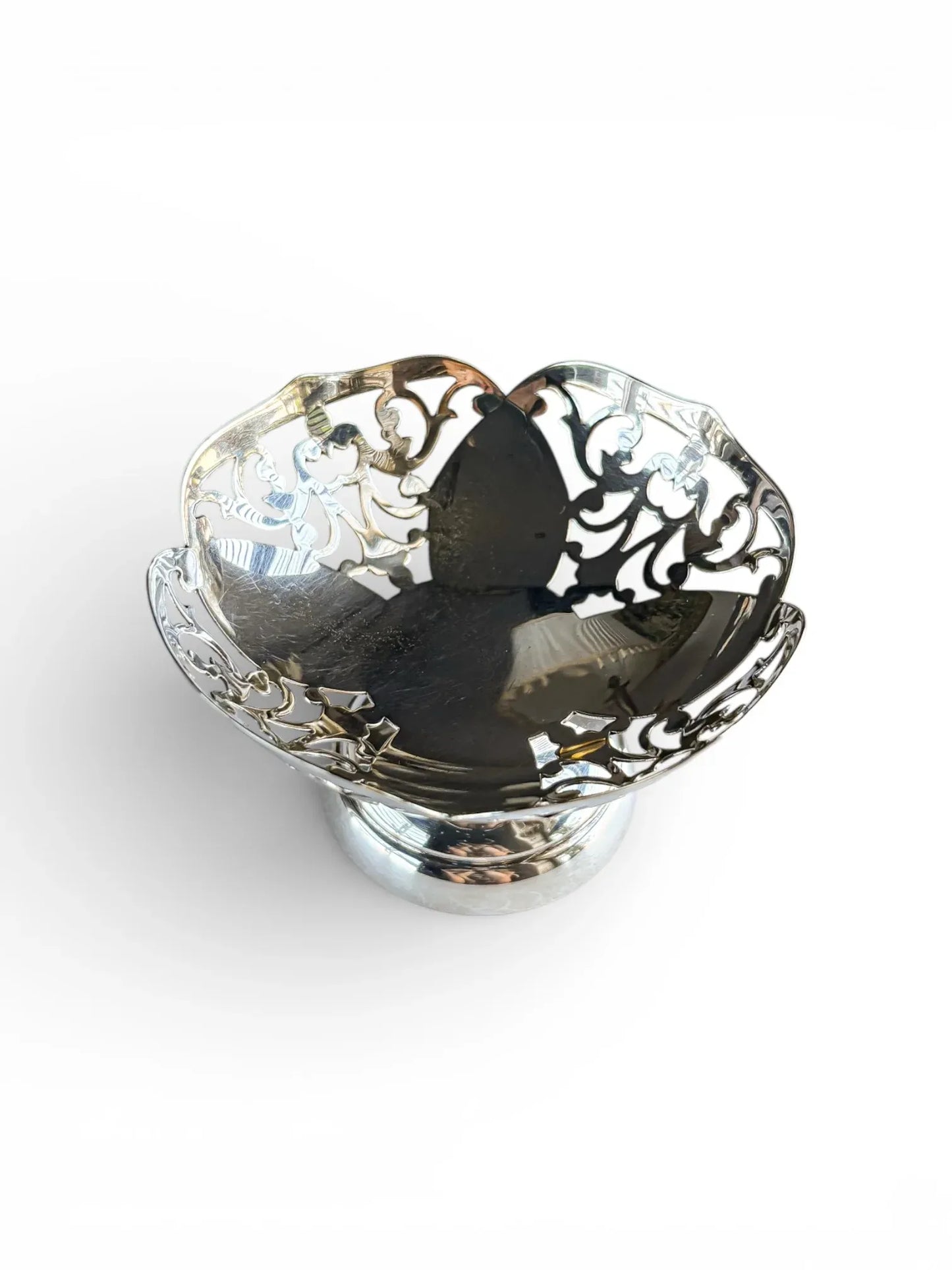 Elevated view of a reticulated silver-plated tazza showing the intricate open-work bowl.