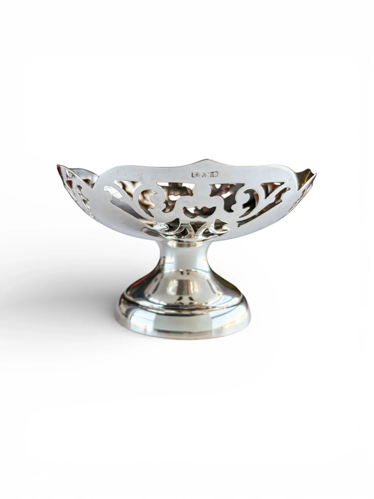 Side profile of a silver-plated pedestal dish featuring the EPNS hallmark on the scalloped rim.
