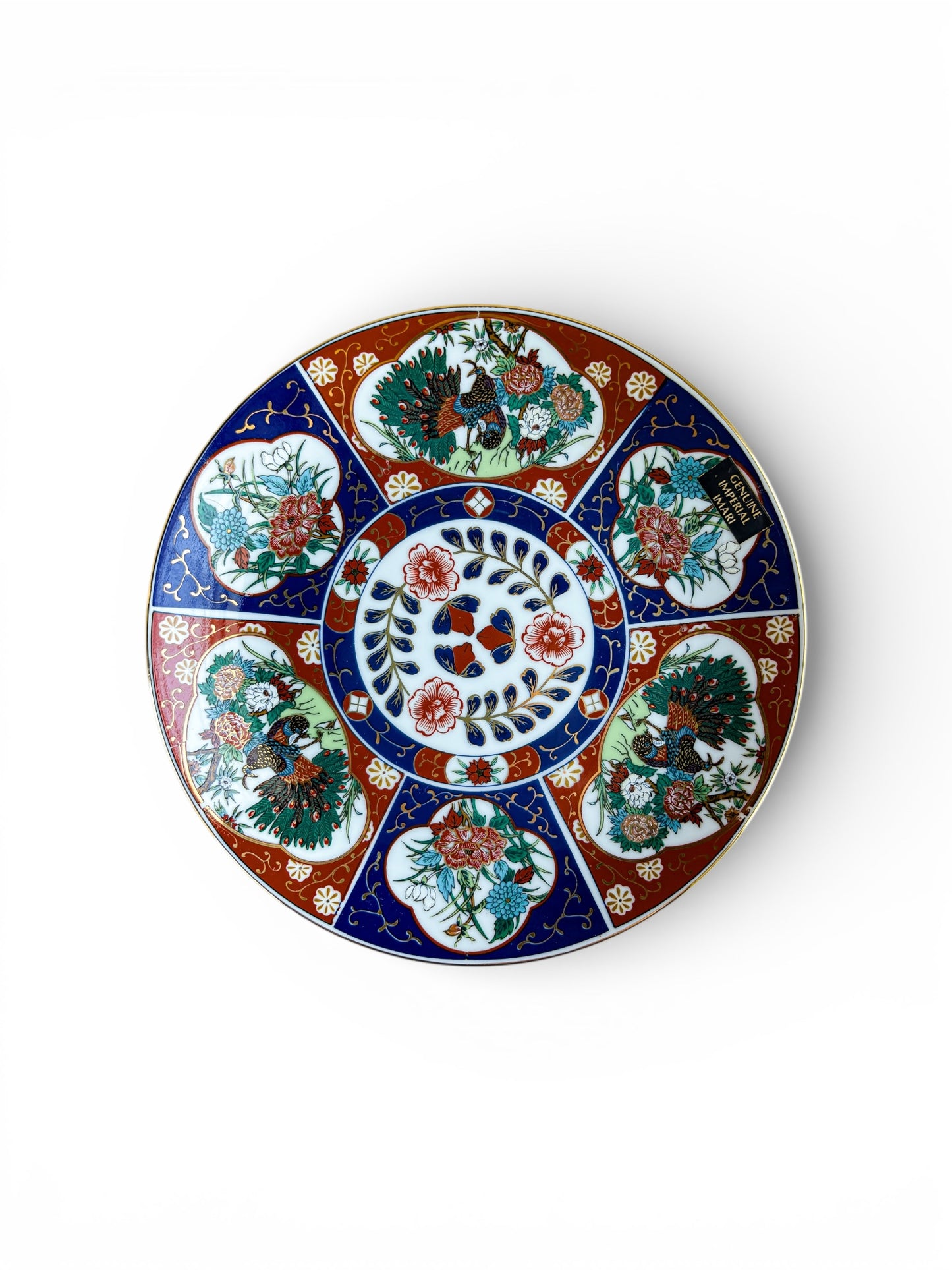 Round porcelain plate with intricate floral and peacock designs in red, blue, and green, labeled Genuine Imperial Imari