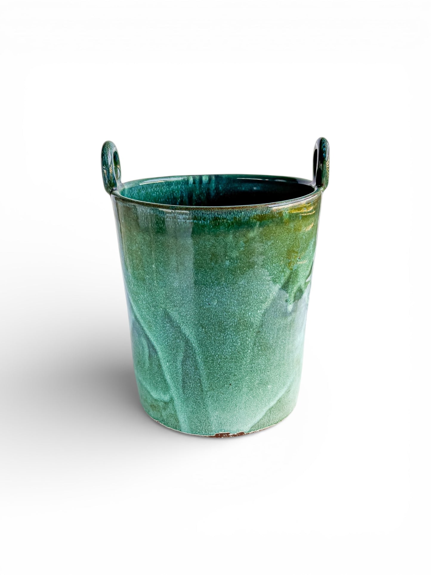 Green glazed ceramic vintage cachepot with side handles on white background