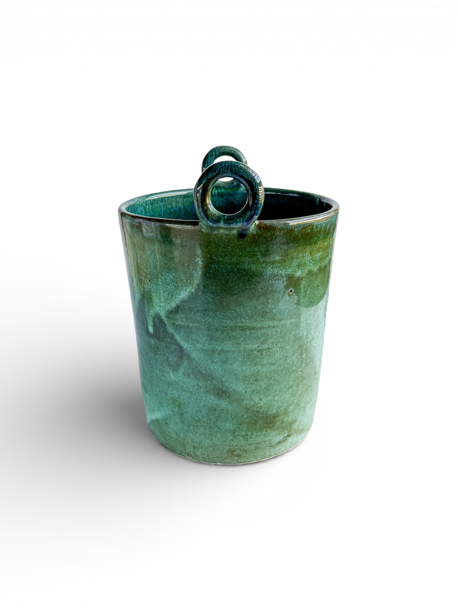 Handmade green glazed ceramic cup with decorative rolled handle, vintage tableware