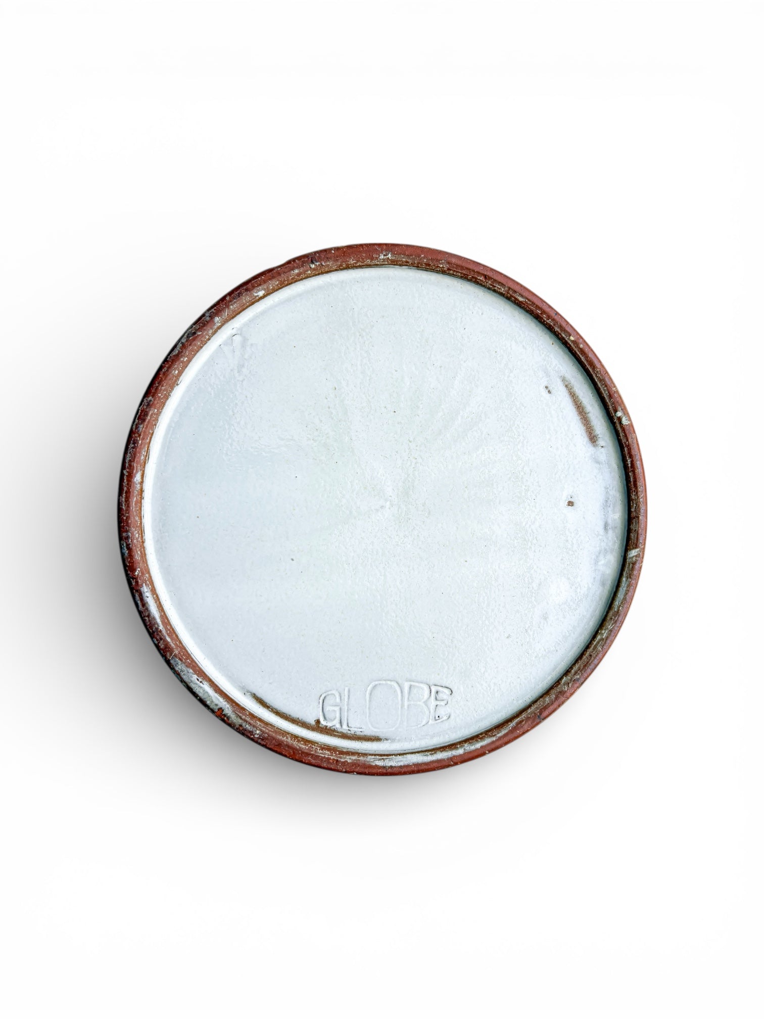 Bottom of vintage ceramic bowl with white glaze and embossed GLOBE mark