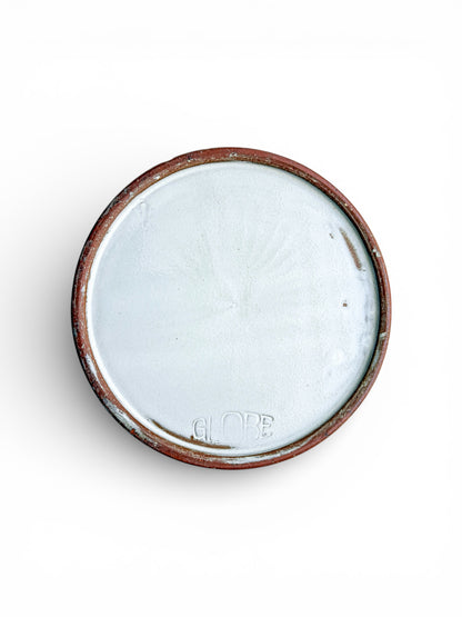 Bottom of vintage ceramic bowl with white glaze and embossed GLOBE mark