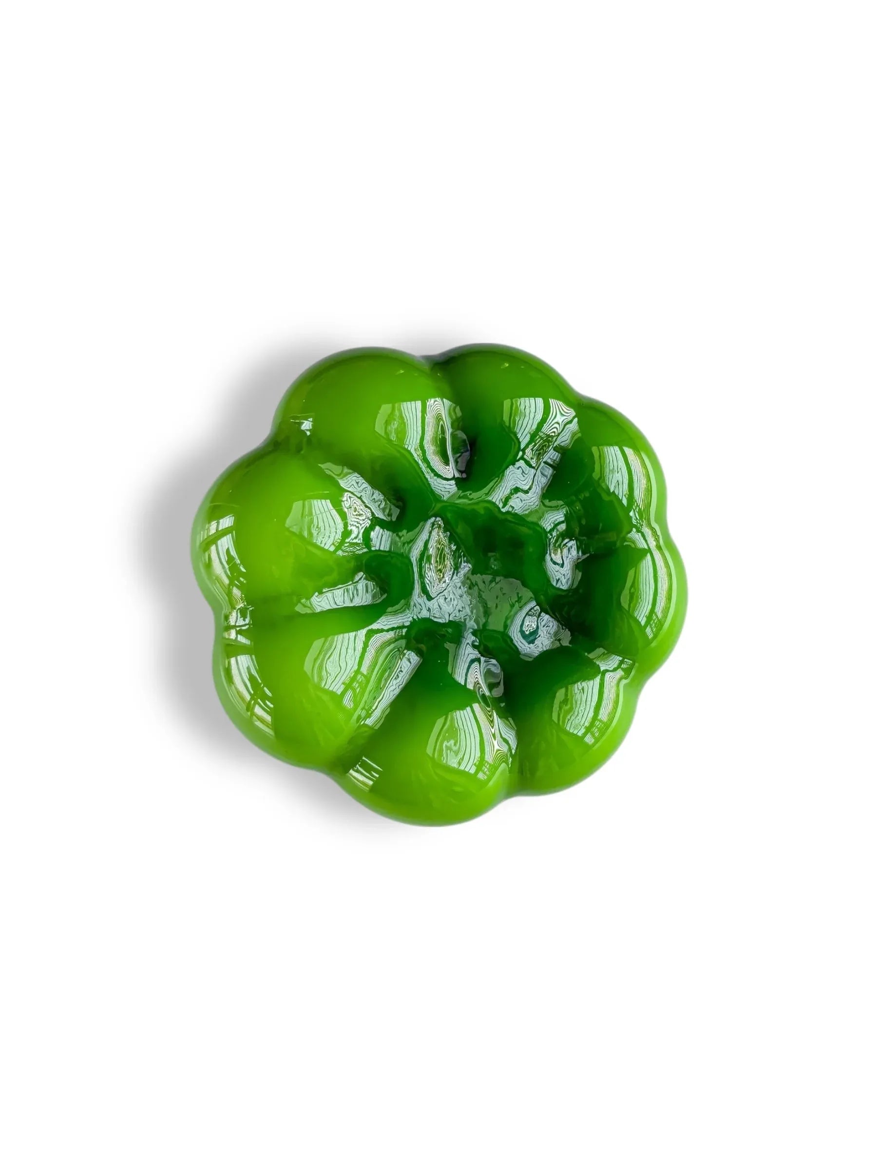 Glossy green ceramic bowl with scalloped edges on a white background