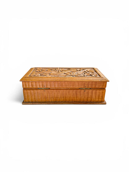 Back view of a Bavarian carved box showing the two original brass hinges and the rhythmic vertical fluting detail along the sides of the honey-toned wood body.