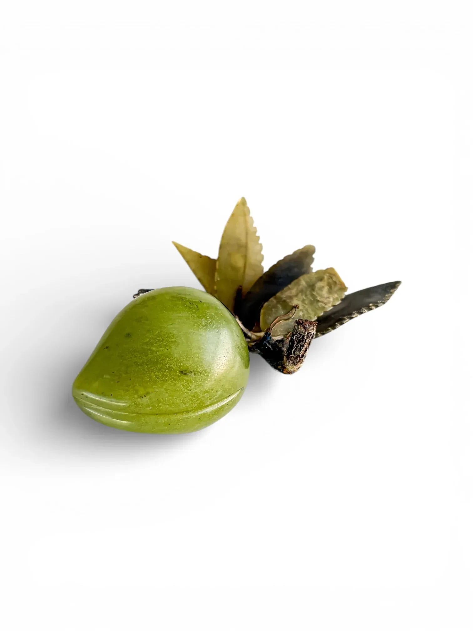 Vintage green jade fruit figurine with metal leaves on white background