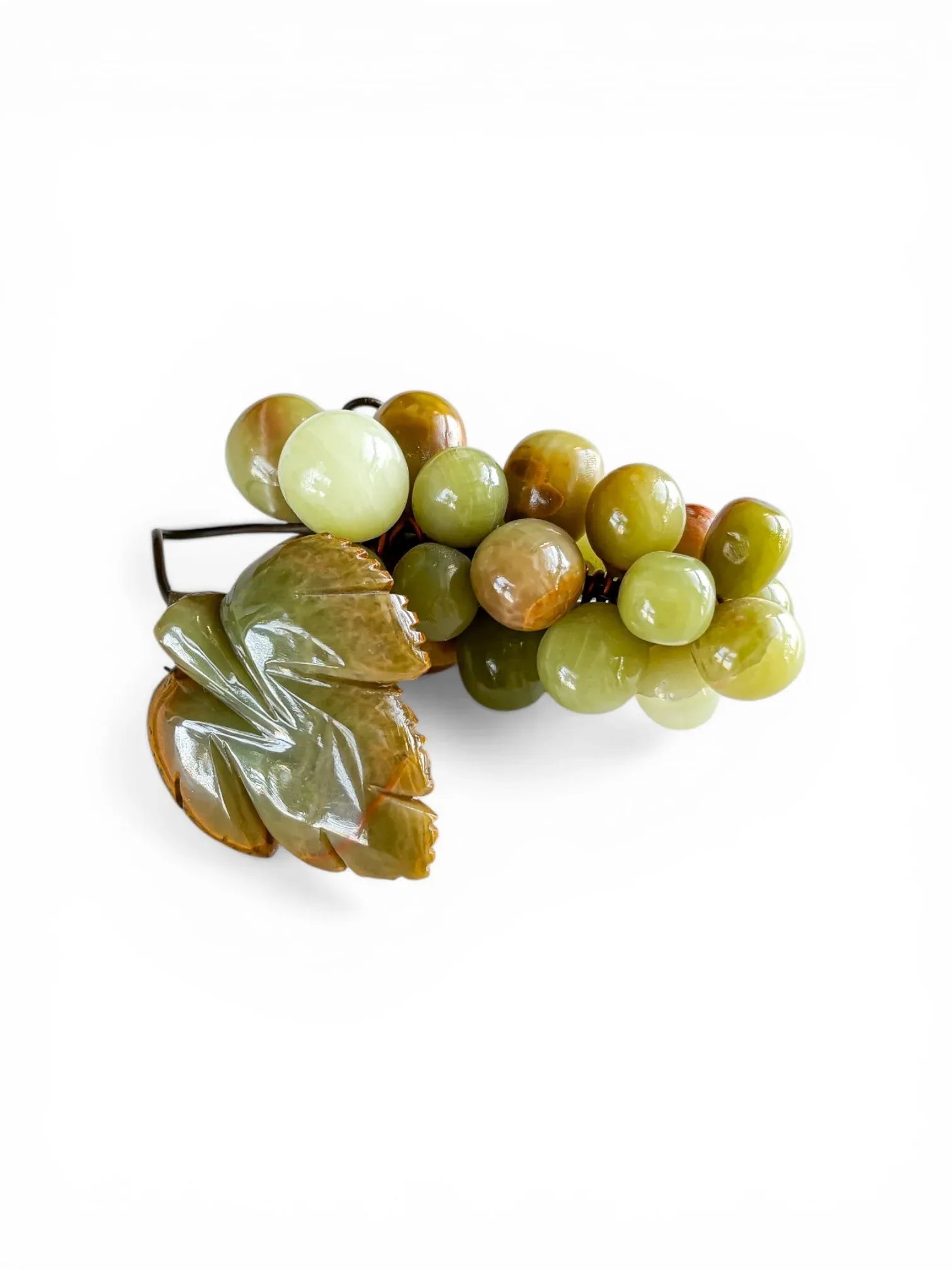 A vintage Mexican onyx grape cluster featuring a hand-carved stone leaf in shades of olive and honey. The polished onyx spheres show natural translucent banding against a crisp white background.