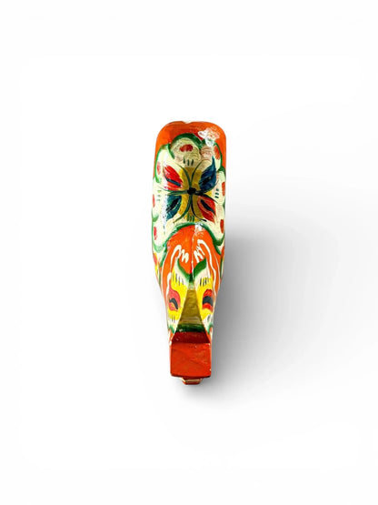 Hand-painted wooden whistle with colorful butterfly and floral design on white background