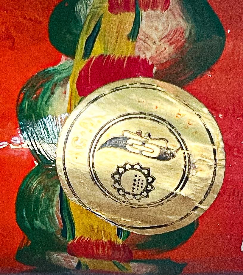 Close-up of a red Swedish Dala horse with hand-painted floral designs and gold emblem detail.