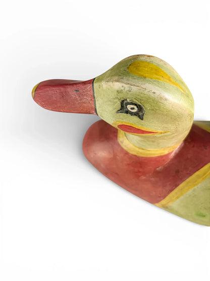Vintage hand-painted wooden duck figurine with colorful details on white background