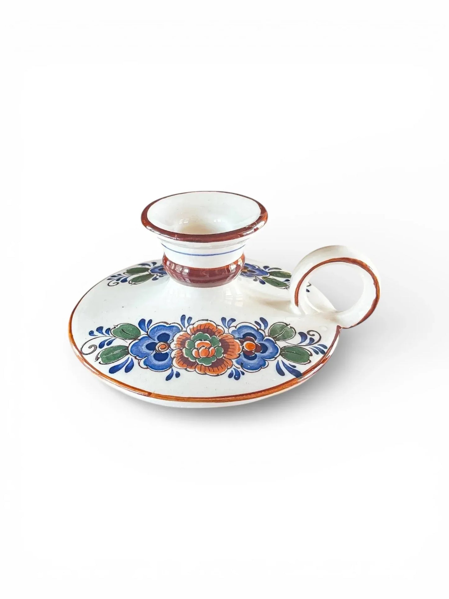 Hand-painted vintage porcelain candlestick holder with floral design on white background