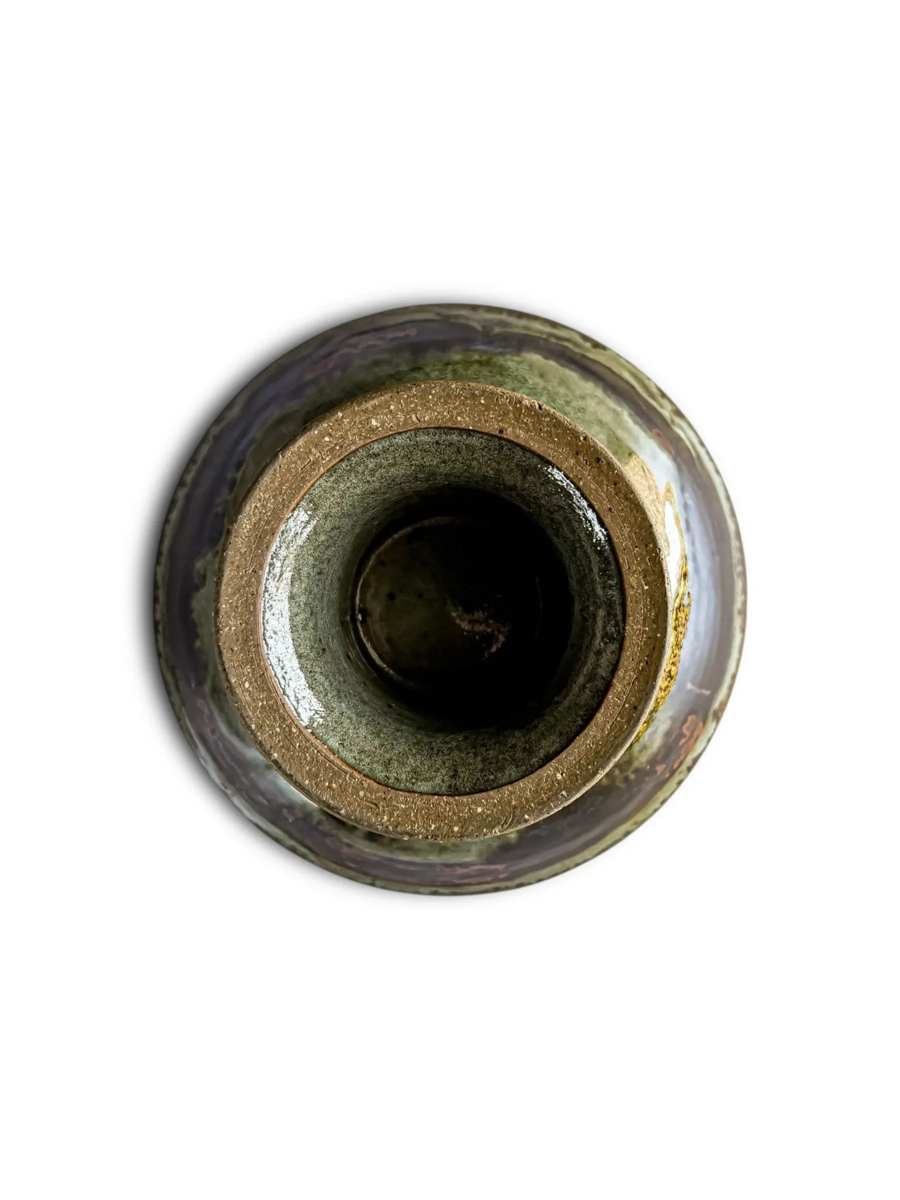 Top view of a rustic ceramic pottery vase with earthy brown and green glaze