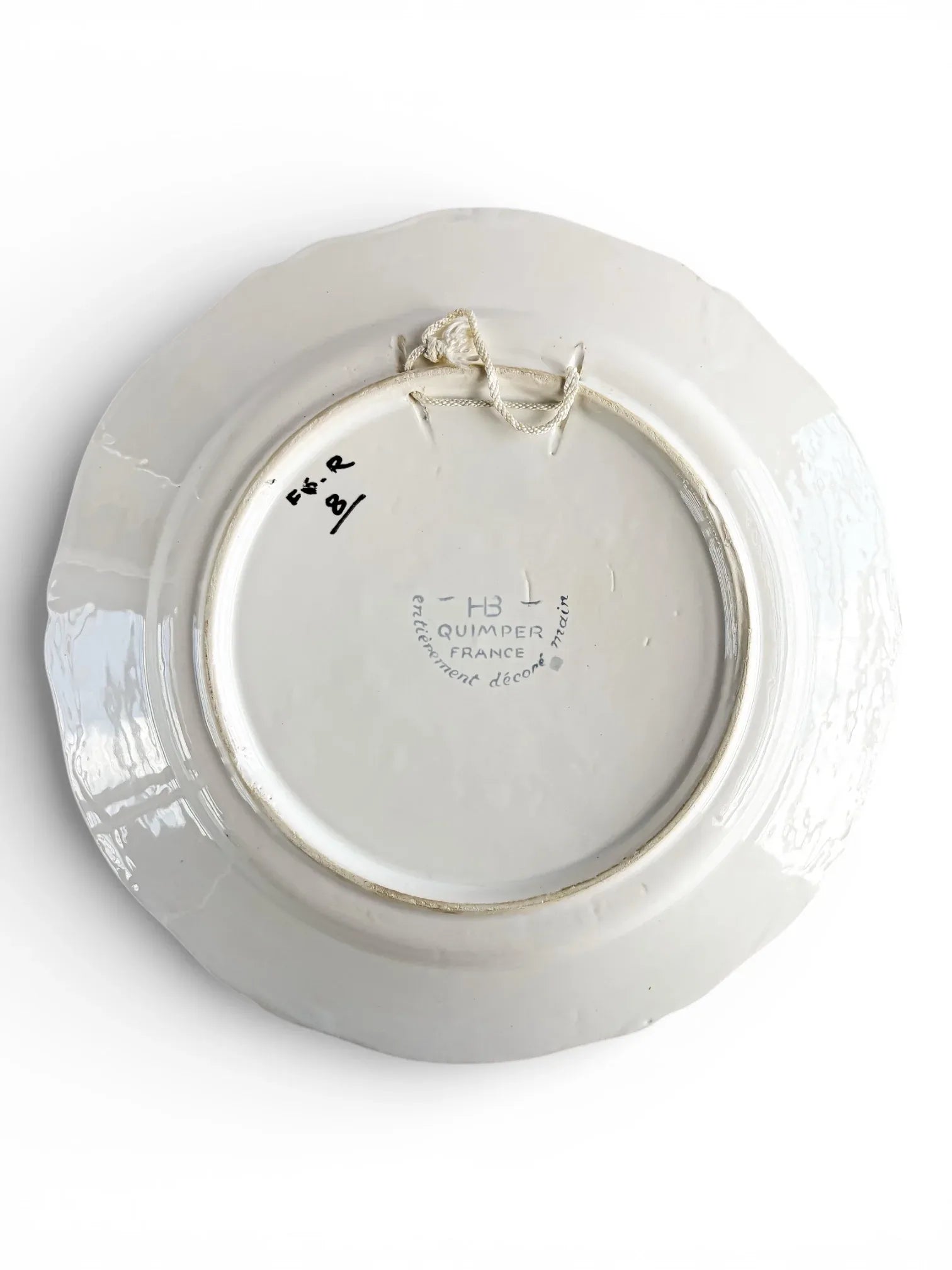 Back of vintage HB Quimper France porcelain plate, white ceramic with hanging string