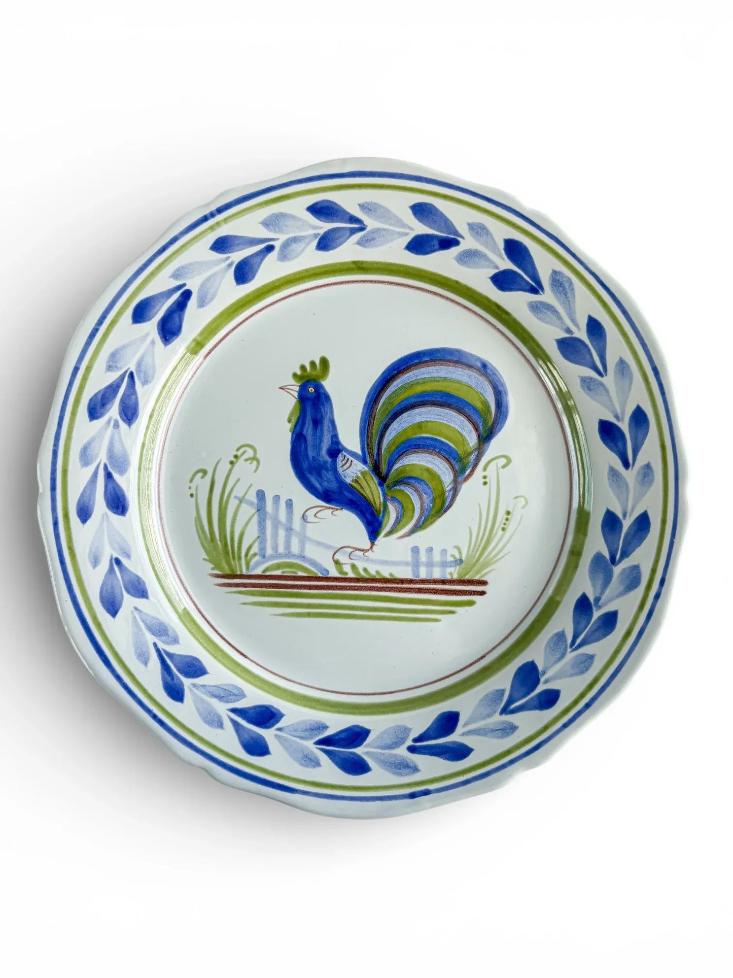 Hand-painted ceramic plate with blue rooster motif and leaf border, vintage tableware