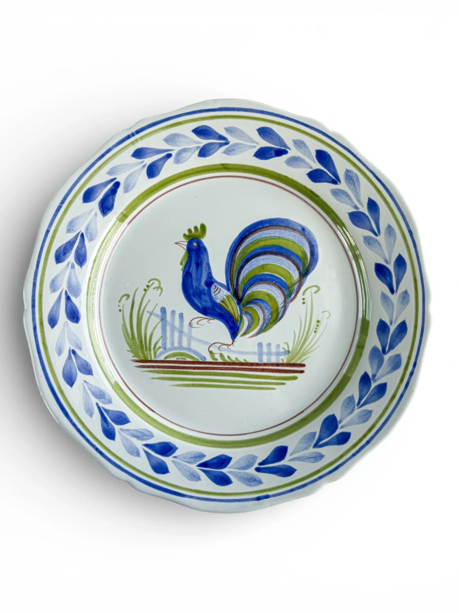Hand-painted ceramic plate with blue rooster motif and leaf border, vintage tableware