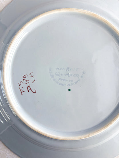 Underside of vintage porcelain plate with Quimper France hallmark and handwritten marks