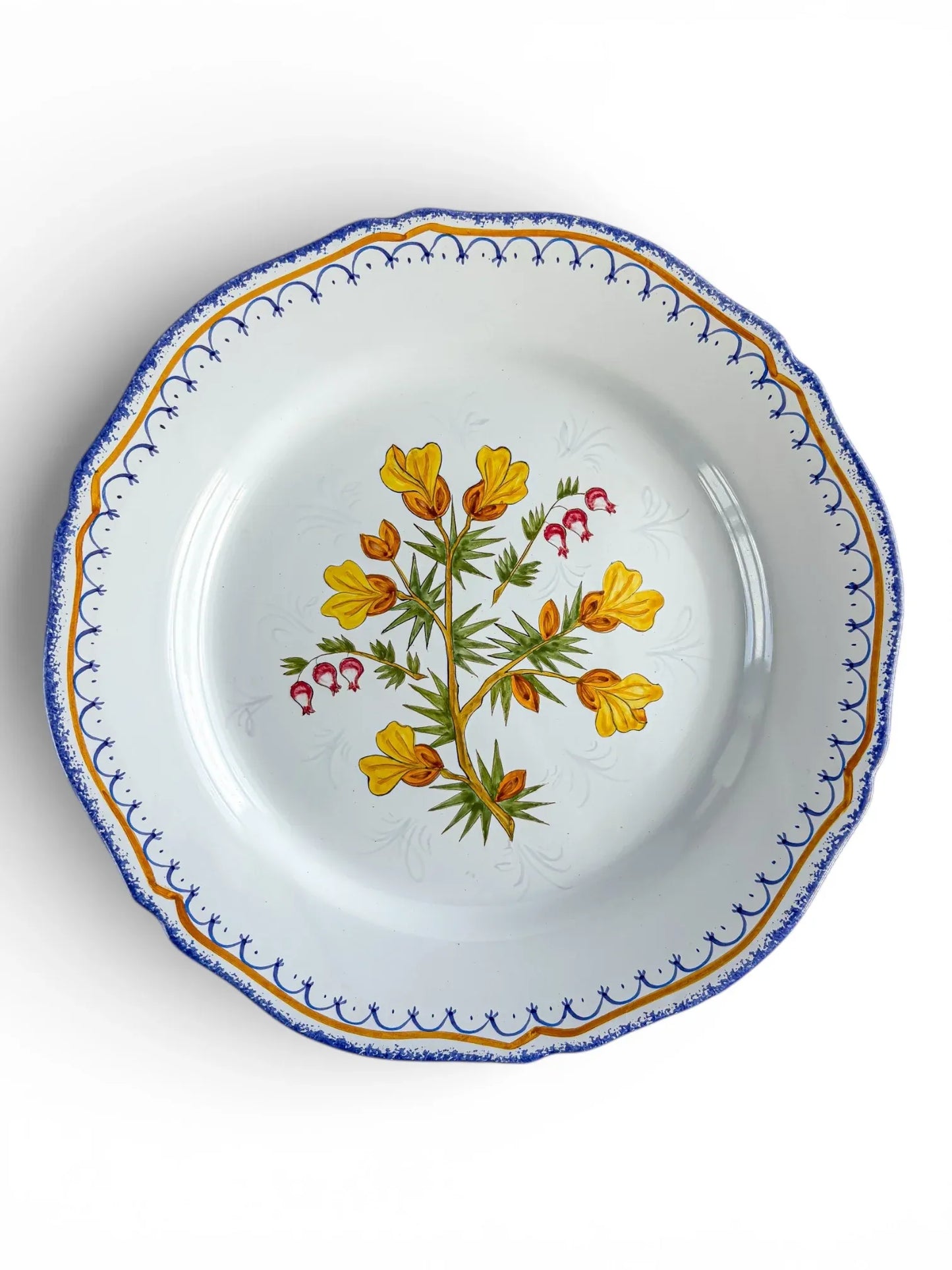 Vintage porcelain plate with blue and gold rim, floral center, and scalloped edge