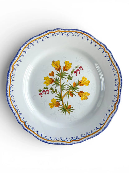Vintage porcelain plate with blue and gold rim, floral center, and scalloped edge