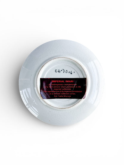 Back of a white Imperial Imari porcelain plate with label detailing 16th century reproduction in limited collectors series