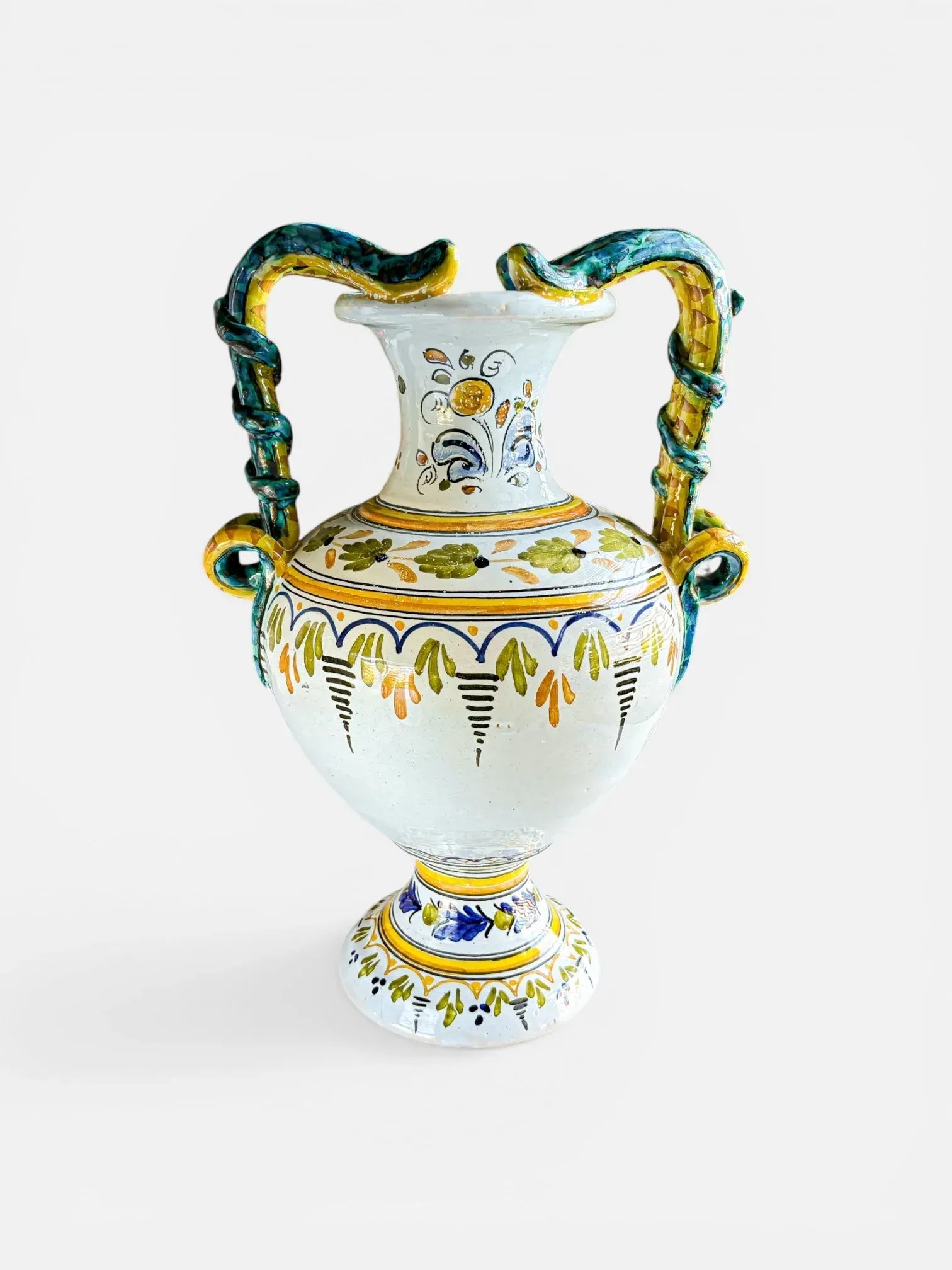 Vintage Italian Majolica amphora with hand-painted Raffaellesco motif and iridescent lustre serpent handles on a crisp white background.