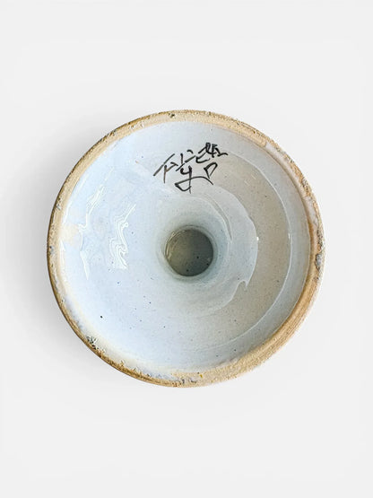 Underside of a vintage Italian pottery urn showing the hand-painted G.D. Italy workshop mark and artisanal glaze texture.
