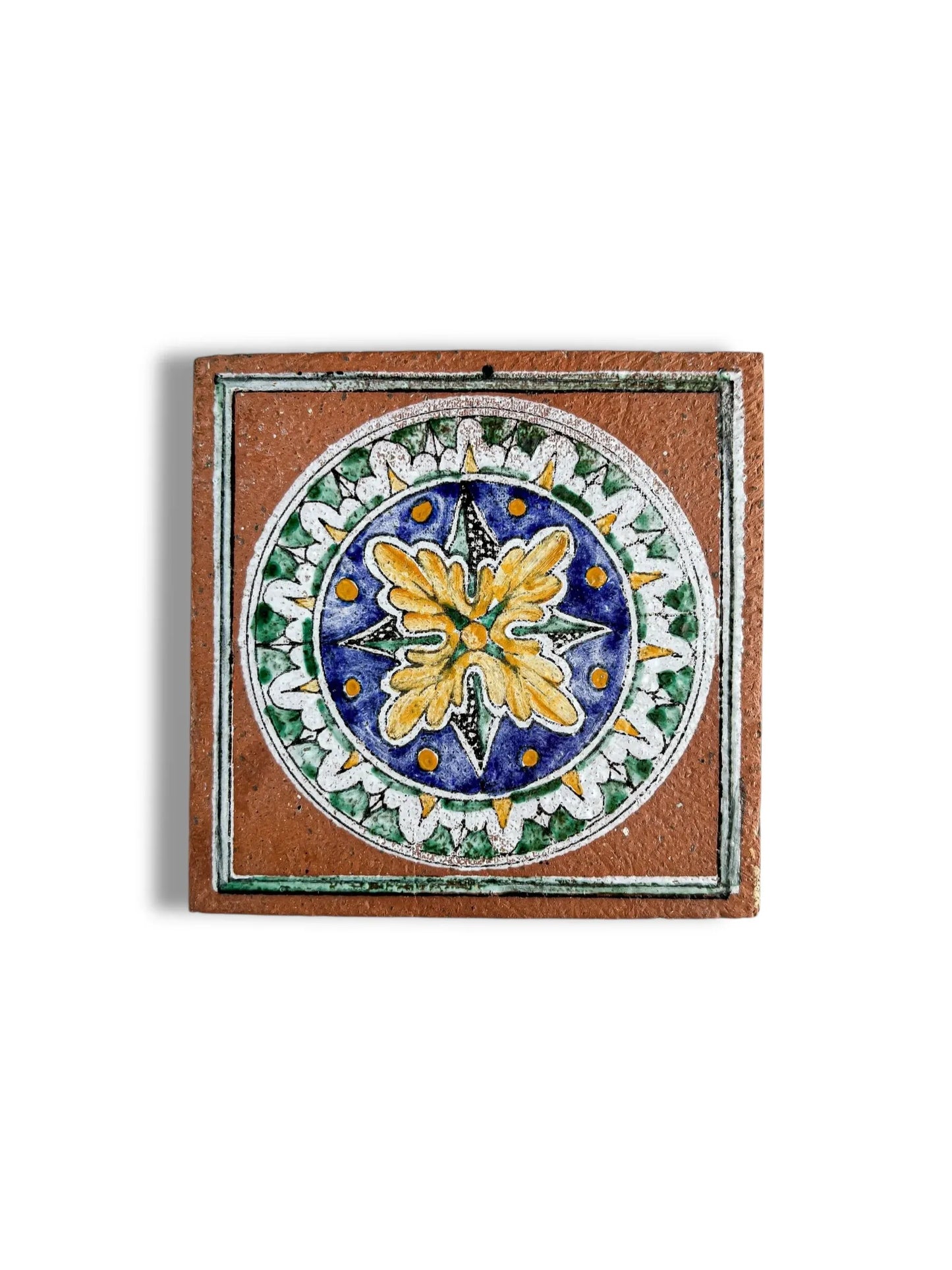 Decorative ceramic tile with colorful circular floral and geometric pattern on terracotta background