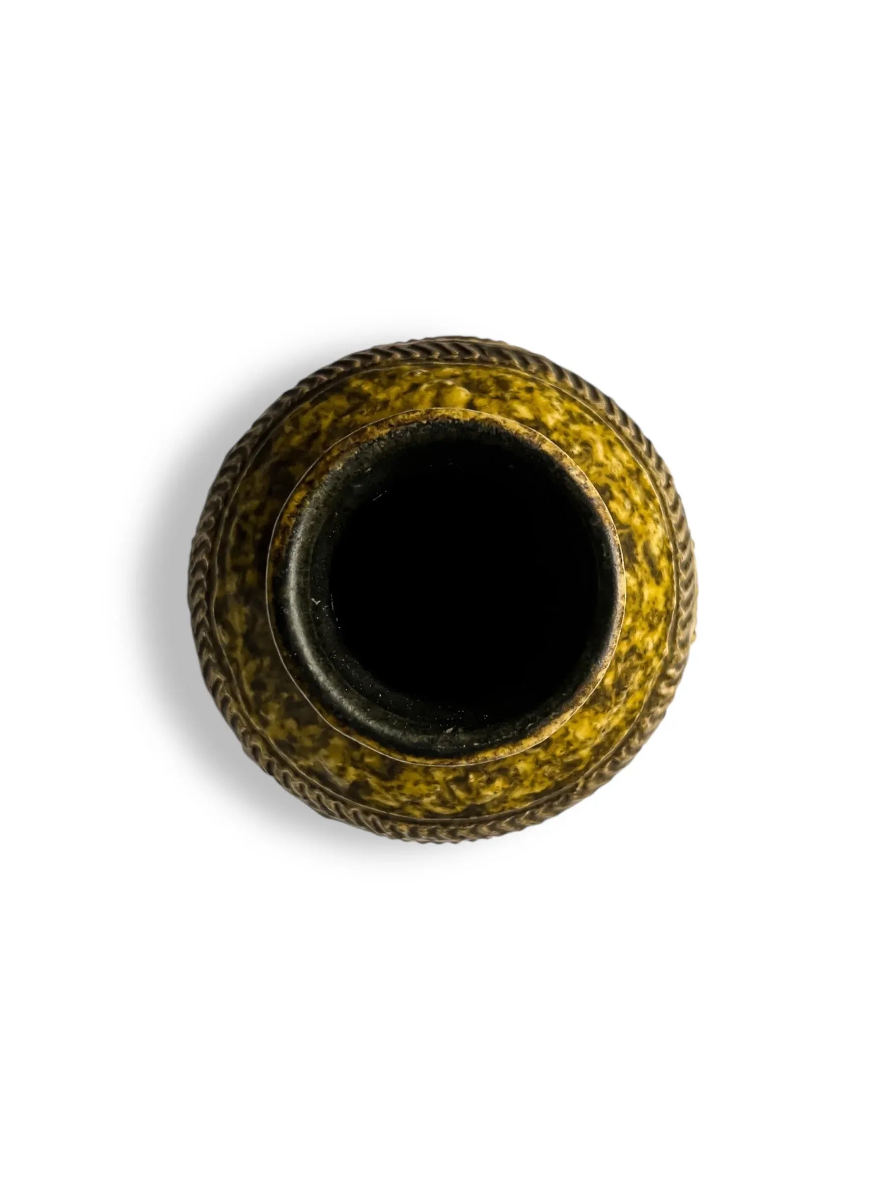 Top view of a vintage yellow ceramic vase with a textured braided rim on white background