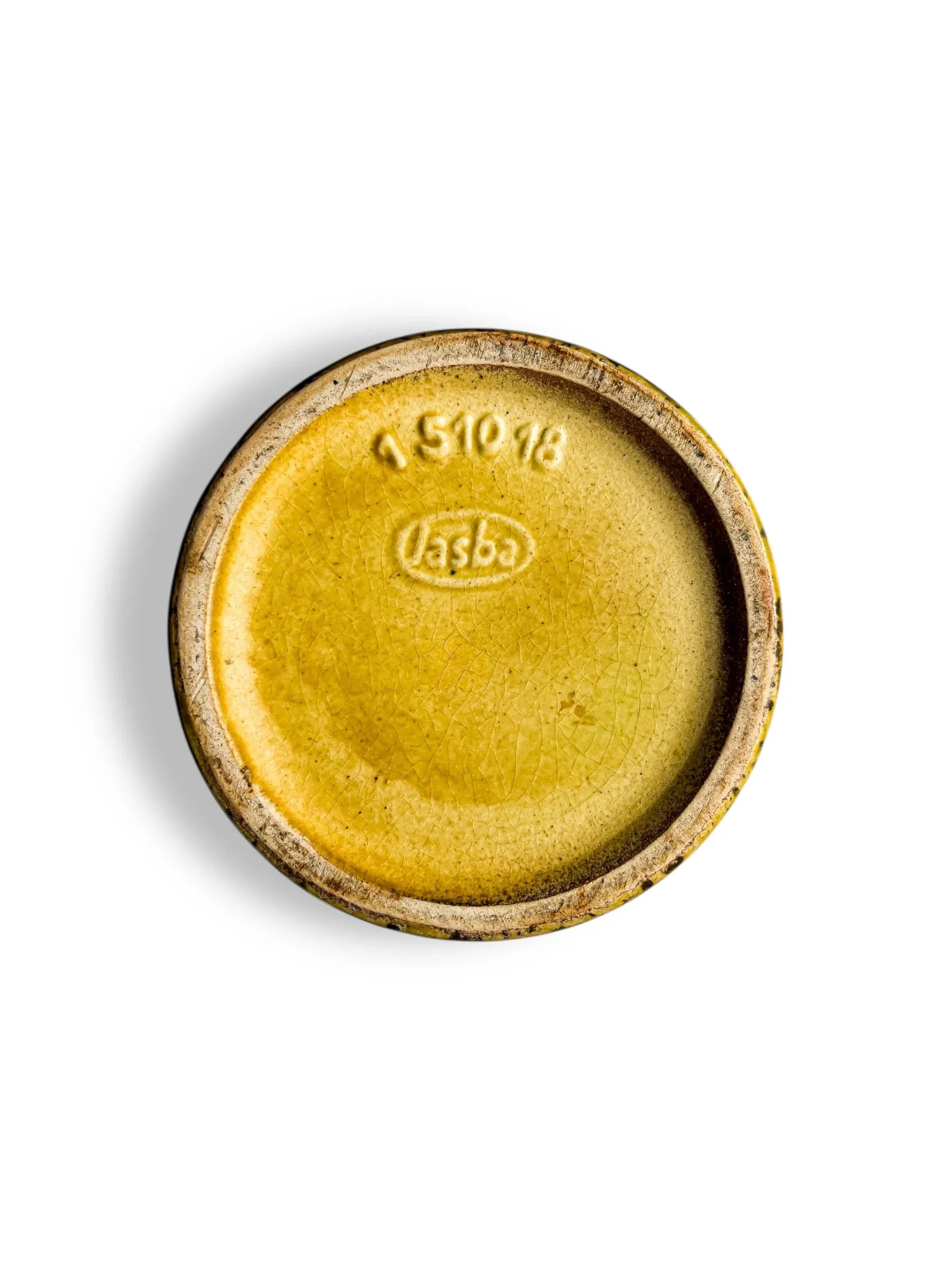 Bottom of a vintage yellow glazed ceramic pot with embossed 'lasba' logo and number 151018