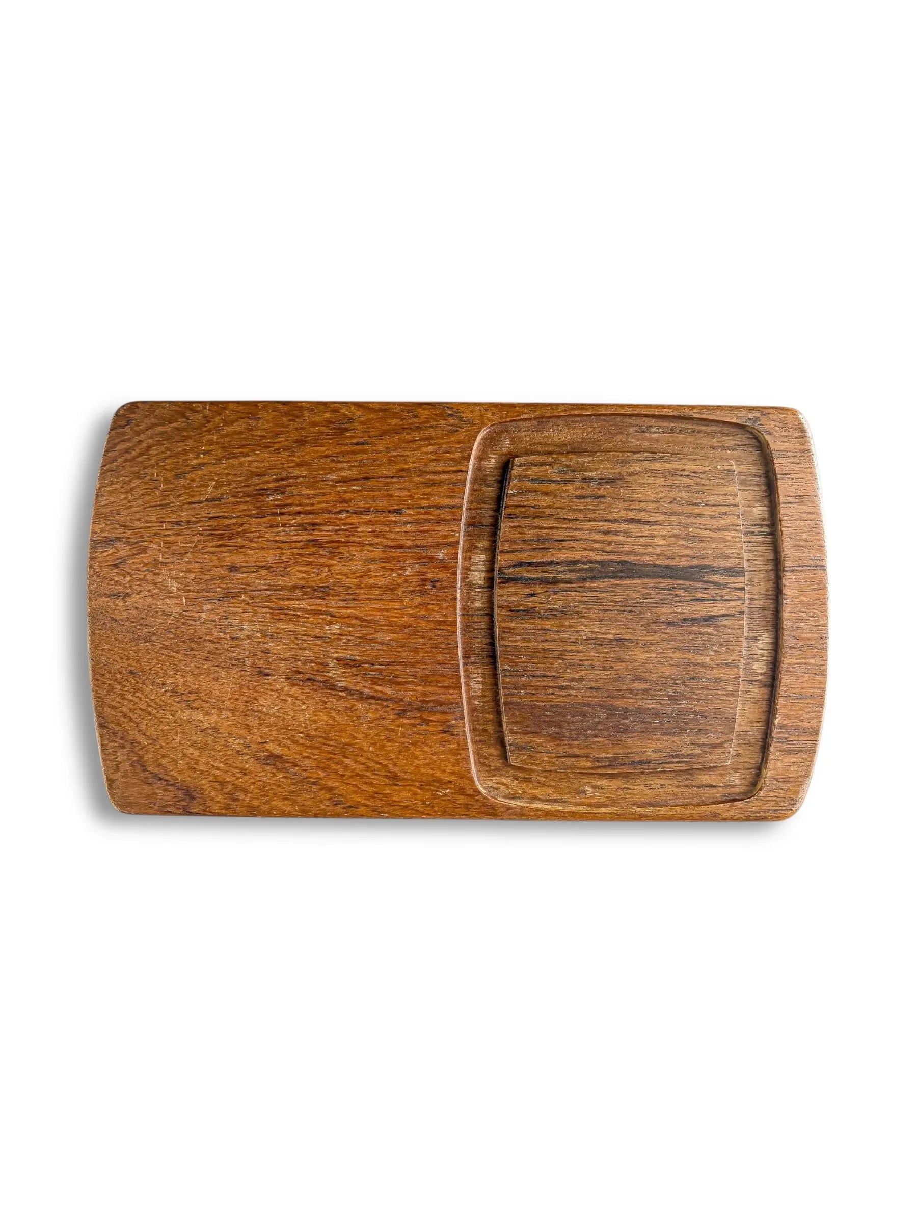 Rectangular wooden cutting board with integrated square section and rich wood grain texture