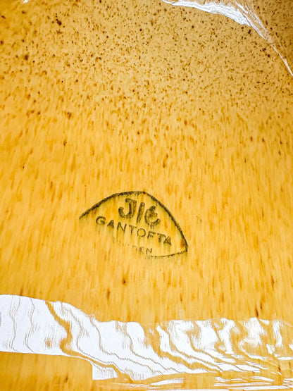 Close-up of natural bamboo surface with 'Jic Santoña' brand stamp and white painted detail