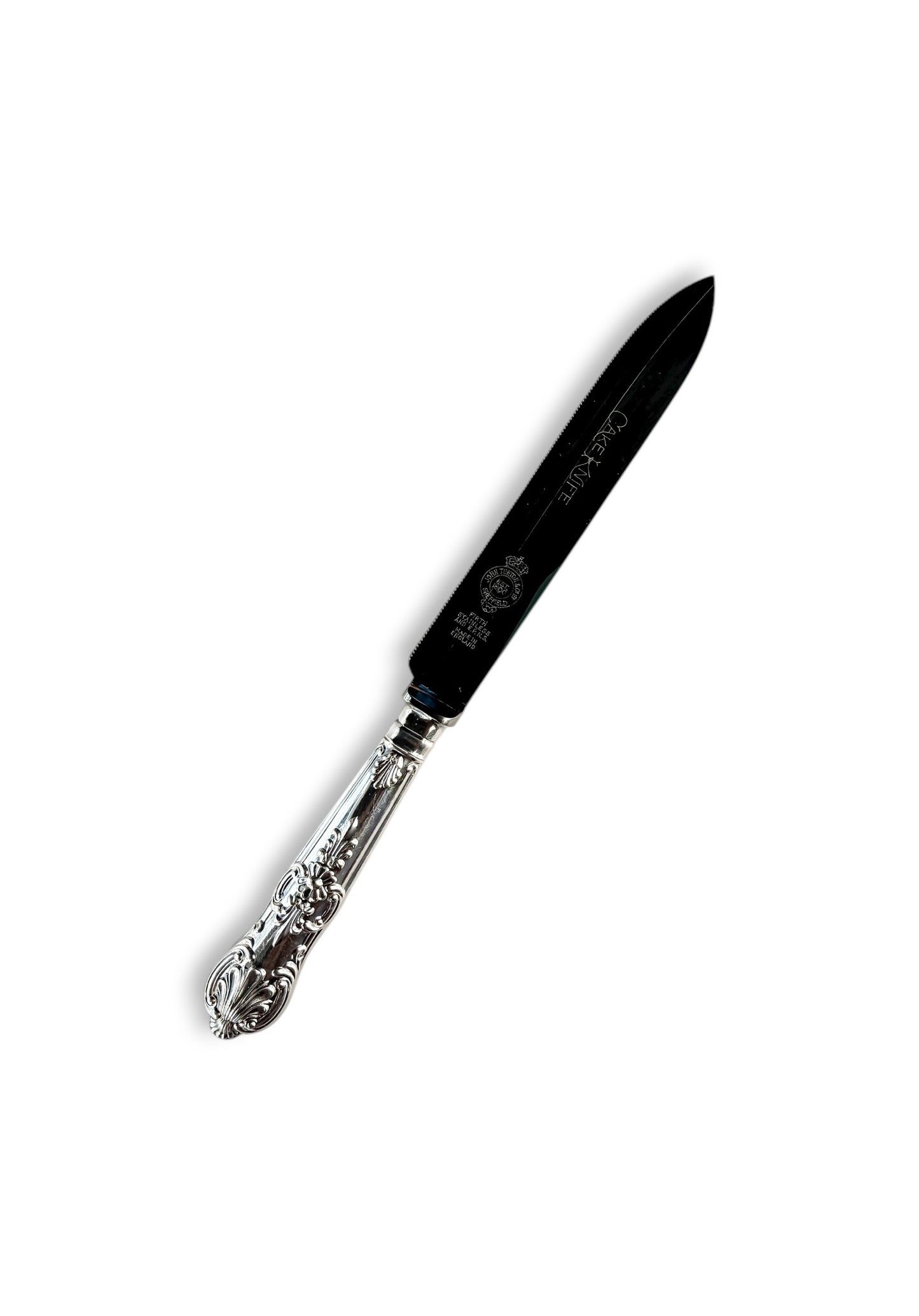Ornate silverplated cake knife with detailed handle on white background