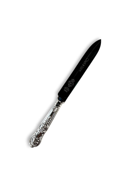 Ornate silverplated cake knife with detailed handle on white background